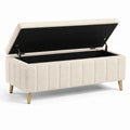 Panca contenitore in tessuto beige con gambe in metallo
